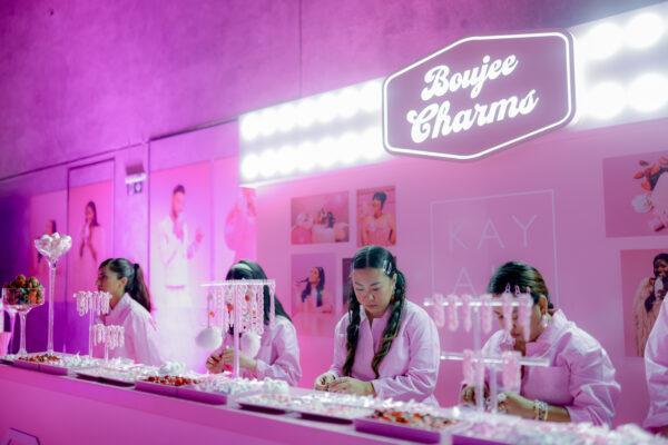 Ladies in pink prepares for the customization area in Kayali Yum Boujee Marshmallow event