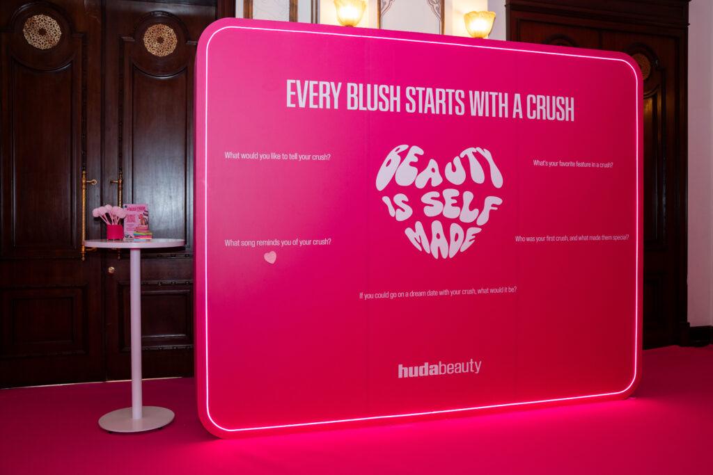 Huda Beauty activation that has post it where you can post your paper on the wall